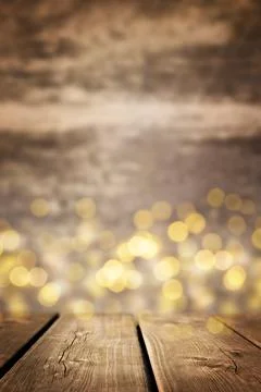 Empty brown rustic wooden table with blurred Christmas lights. New year mood. Stock Photos