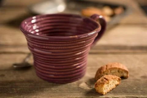 Empty Brown Teacup Between Spoon and Biscuits Stock Photos