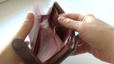 Empty brown wallet. A wallet without money. Opened the purse and got upset. Stock Footage 76615084