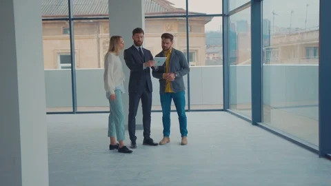 In empty building real estate agent showing couple new apartment e look around Stock Footage 129524381