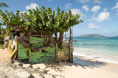 Empty building on Tortola sandy beach with crystal water Stock Photos