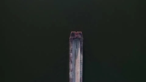 Empty bulk carrier ship passing underneath in dark green water. Top-down view Stock Footage 204739106