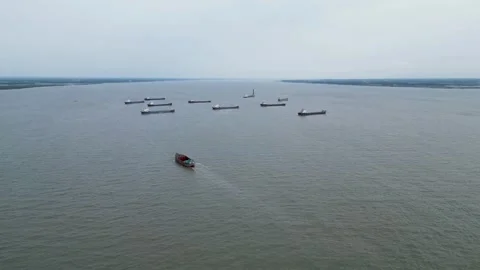 An empty bulkhead ship navigating through an estuary on its way  Stock Footage 287782070