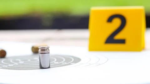An empty bullet casing on a shooting target background, with a blurred blac.. Stock Photos