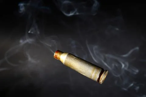 Empty bullet shell casings, on a black background, smoke Stock Photos