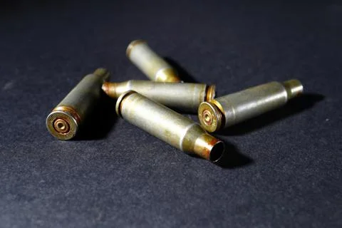 Empty bullet shell casings, on a black background, smoke Stock-Fotos