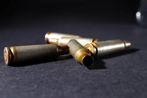 Empty bullet shell casings, on a black background, smoke Stock Photos