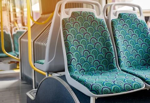 Empty bus interior with seats and railings Stock Photos