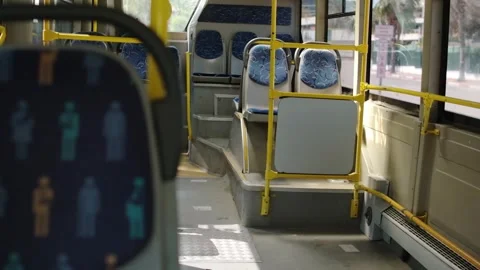 Empty Bus Interior With Shadows on the Floor and Bright Sunlight Streaming Stock Footage 312600817