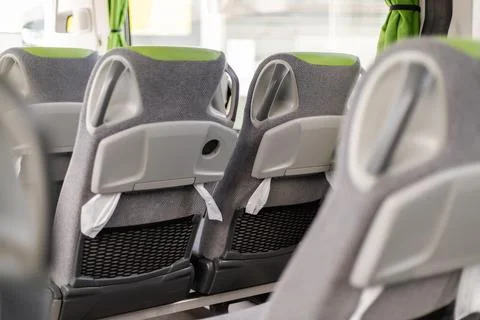 Empty bus interior showing rows of comfortable seats in a modern design wit.. Stock Photos