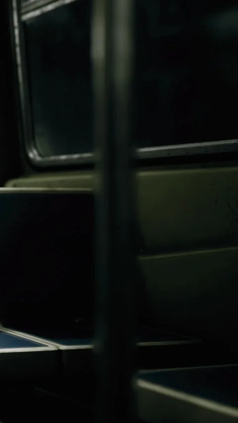 Empty bus seats in a dimly lit public transport setting during the evening Stock Footage 334250586