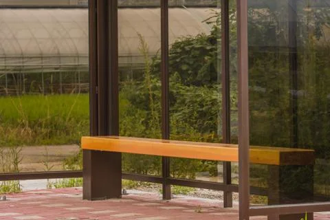 Empty bus stop bench Stock Photos