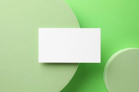 Empty business card and decorative elements on light green background, top .. Stock Photos