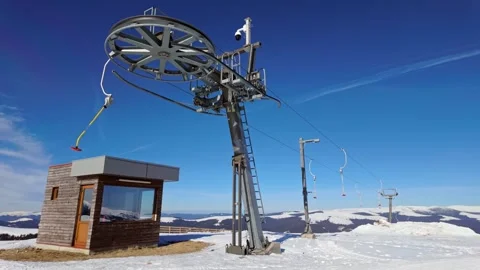 Empty button lift station return end at Transalpina ski resort on a sunny Stock Footage 306436530