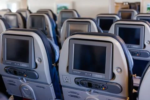 Empty cabin of a large aircraft with rows of seats Stock-Fotos
