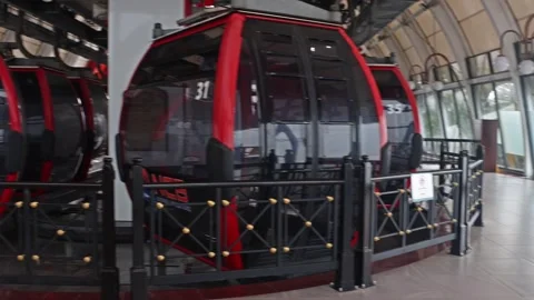 Empty cable cars wait at the cable car station until the heavy rain Stock Footage 315430201