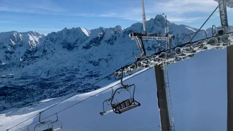 Empty cableway in the mountains on the ski slope in the sunny day, high Stock Footage 190951291