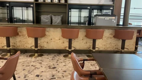 Empty cafe bar interior with brown chairs and terrazzo floor, featuring a m.. Stock Footage 332064264