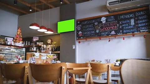 Empty Cafe in Buenos Aires with a TV Green Screen mounted on Wall. Zoom In.  Stock Footage 122229444
