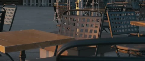 Empty cafè chairs outside during sunrise Stock Footage 252266375