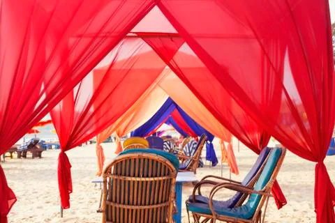 Empty cafe with many colored canopy, baldachin tunnel looling on the seashore Stock Photos