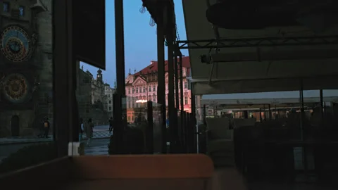 Empty cafe on old town square with astronomical clock during coronavirus Видео 142753762