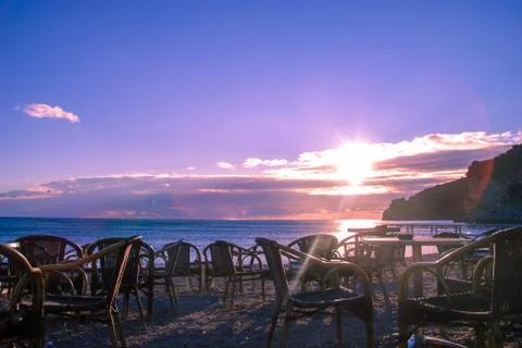 Empty cafe at sunset by the sea Stock Photos