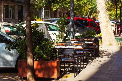 Empty cafe table on the street by the side of the road on a sunny summer day 스톡 사진