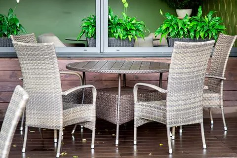 Empty cafe terrace with round tables and wicker chairs nobody. Stock Photos
