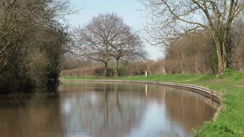 Empty canal on sunny day with trees reflecting in water Video stock 74193323