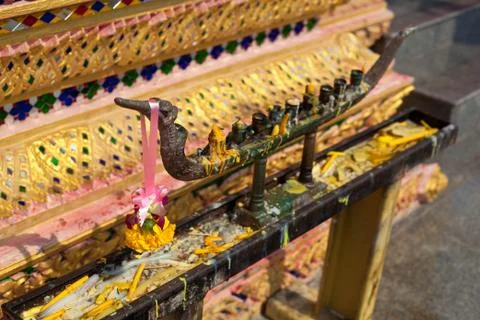 Empty candlestick with some flower petals in buddhist temple Stock Photos