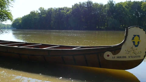 Empty canoe on Wabash River with sun flares Stock Footage 168093368