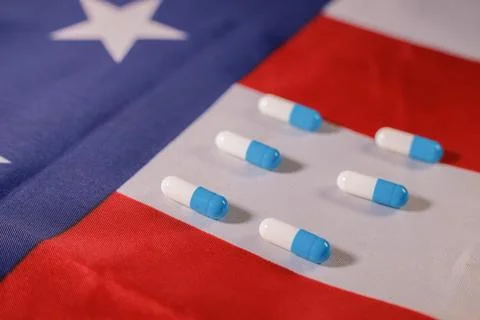Empty capsule capsules on the USA flag. The medical system Stock Photos