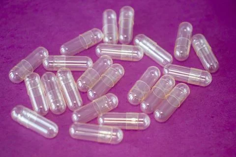 Empty capsule pill on a bright pink background Stock Photos