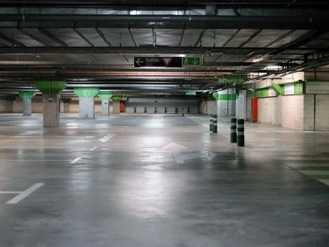 Empty car parking with columns and signs on the floor Stock Photos