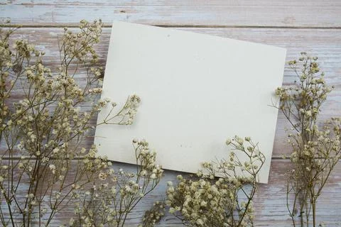 Empty card for text message and flower decoration on wooden background Stock Photos