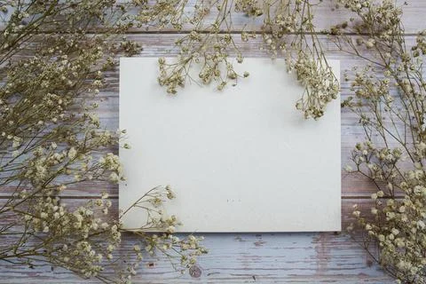 Empty card for text message and flower decoration on wooden background Stock Photos