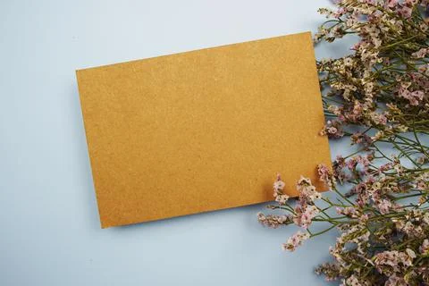Empty card for text message and flower decoration on blue background Stock Photos
