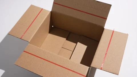 Empty cardboard box rotates under clean studio lighting. Stock Footage 327543445
