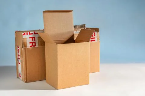 Empty cardboard boxes on white and blue background 写真素材