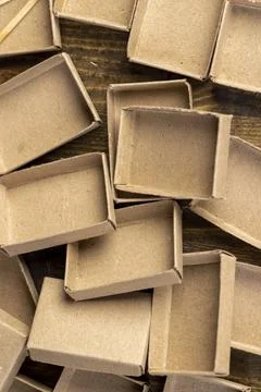 Empty cardboard matchboxes are scattered in a chaotic manner Stock Photos