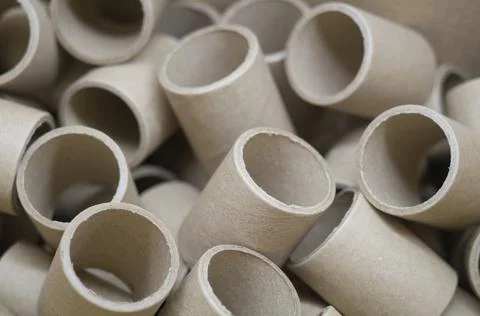 Empty cardboard spools in bulk in a box. Reels with a diameter of 40 mm for Stock Photos