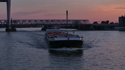 Empty Cargo container ship sails sunset landscape river in Netherlands, aerial Stock Footage 296307066
