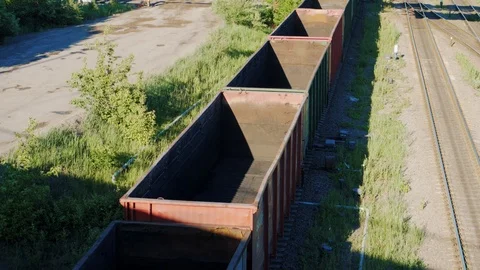 Empty cargo freight train wagoons go on railroad in industrial zone Stock-Footage 90524906