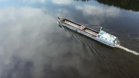 Empty cargo ship barge circle around Stockbeeldmateriaal 154501457