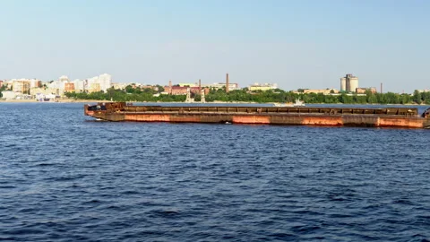Empty cargo ship barge floats on the river on the background of the city 4k Stock Footage 157073113