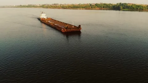 An empty cargo ship floats in the middle of the river. Stock Footage 142350126