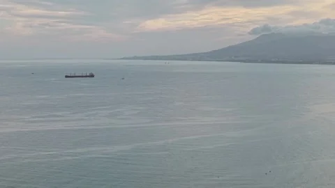 Empty cargo ship sailing alone on wide ocean in overcast weather, Málaga, Spain. Stock Footage 318950603