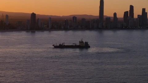 Empty cargo ship sailing in the calm sea against skyline at dusk Stock-Footage 80996682
