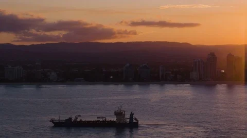 Empty cargo ship sailing in the calm sea against skyline at dusk Stock Footage 80996743